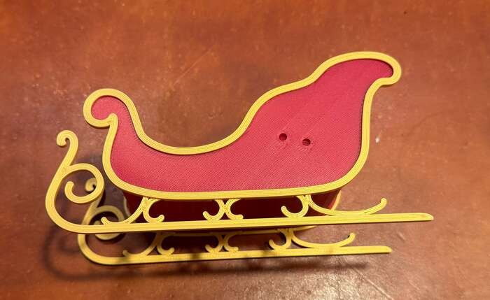 Attach ornamental border to the sides of the sleigh